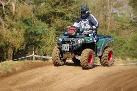 ATV driving through a forest setting.